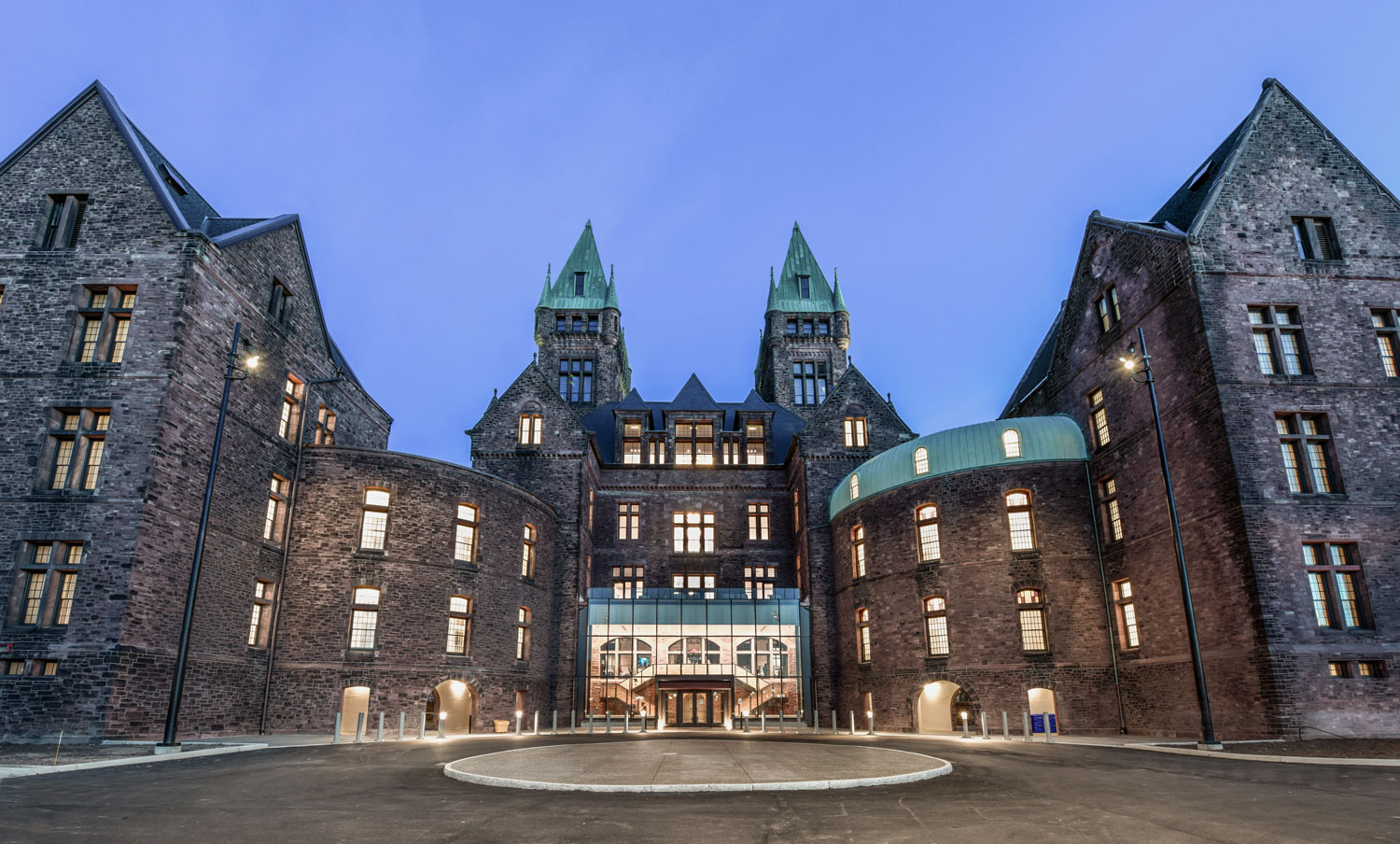 Photo of the exterior of the main building from the parking lot at dusk