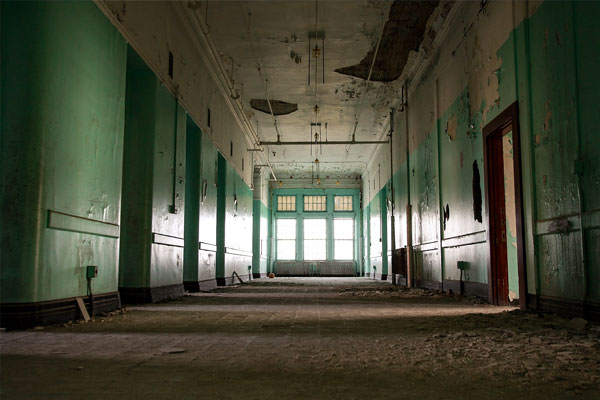 Photo of the interior of the Richardson Olmsted Campus with peeling paint and crumbling plaster by Militello Photography